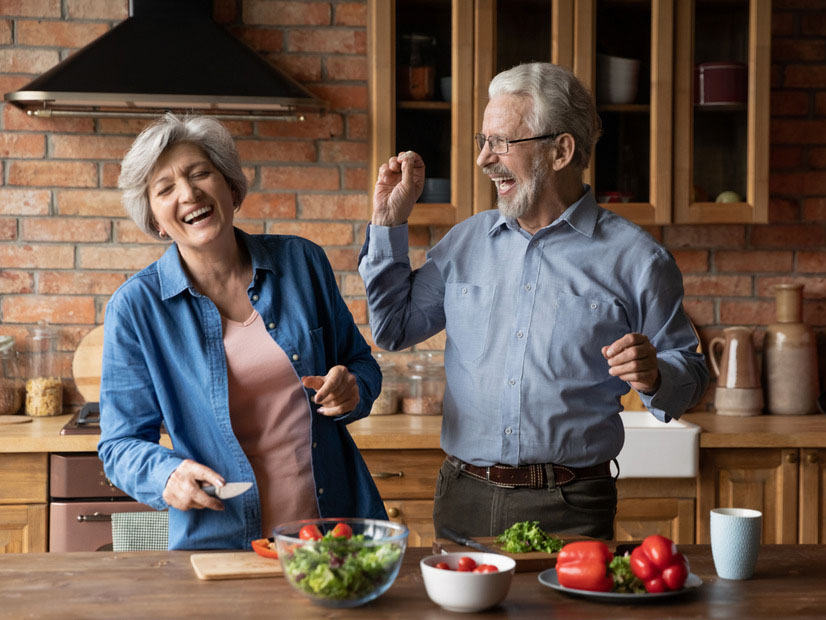 An image of two elderly couple having fun in the kitchen